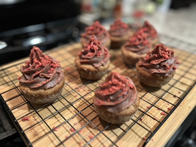 Vegan cupcakes with date frosting topped with dehydrated strawberries