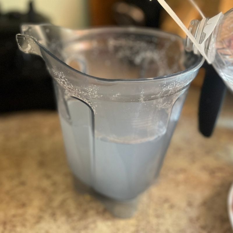 water in a blender sitting on a counter top.