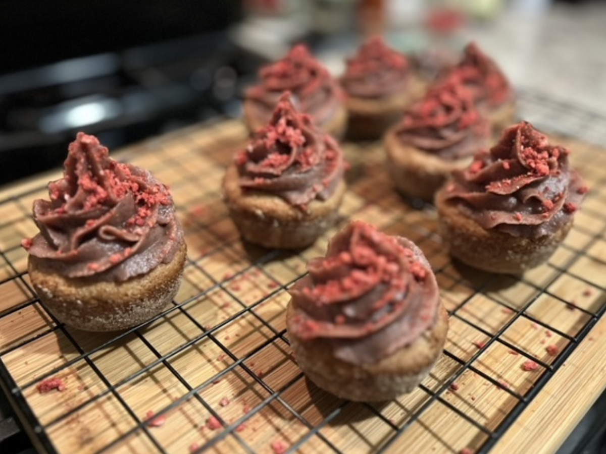 Vegan cupcakes with date frosting topped with dehydrated strawberries