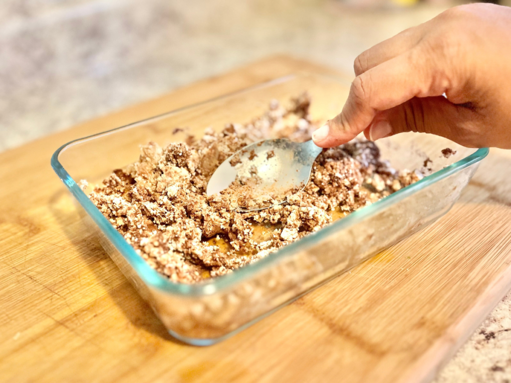 mixed almond pulp and chocolate with a hand and silver spoon